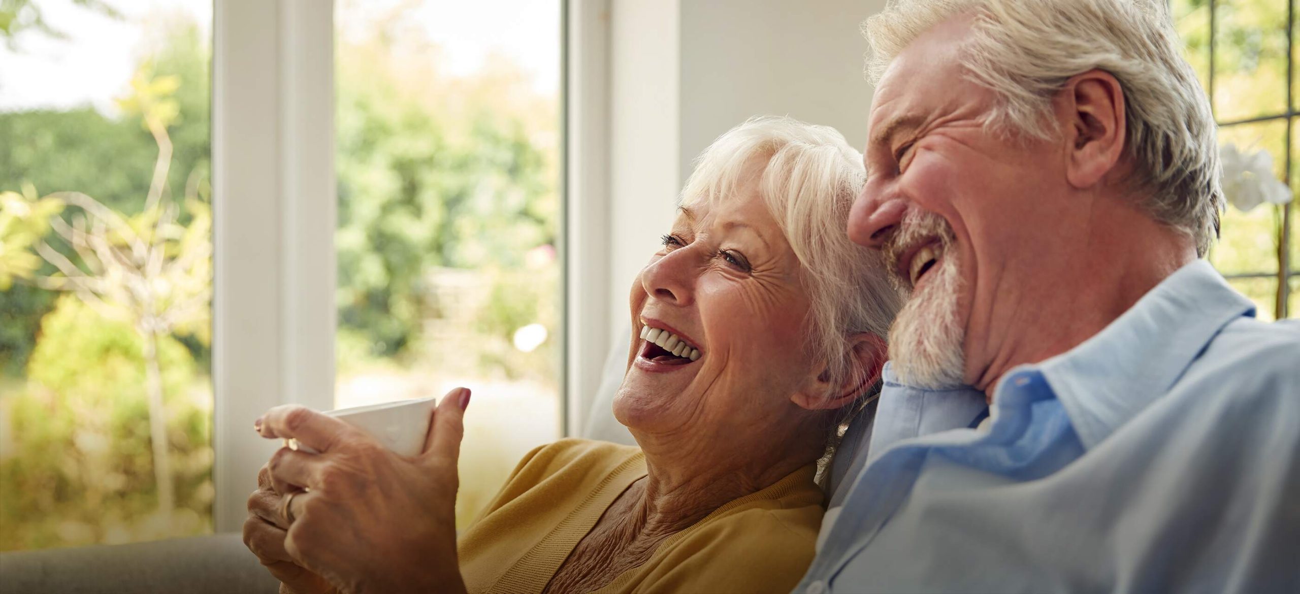 Varenita of Simi Valley assisted living couple laughing on couch