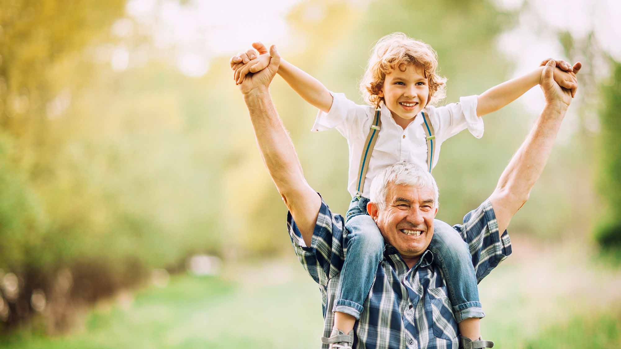 senior with grandchild on his shoulders at Varenita of Simi Valley retirement community