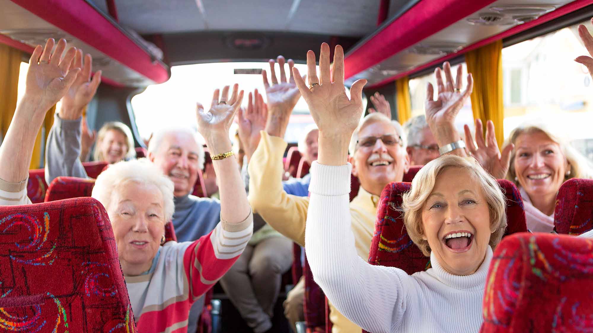 Seniors on a bus taking a day trip with their senior living community