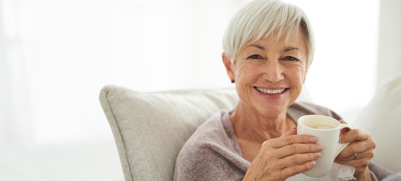 elderly woman with dementia enjoying coffee