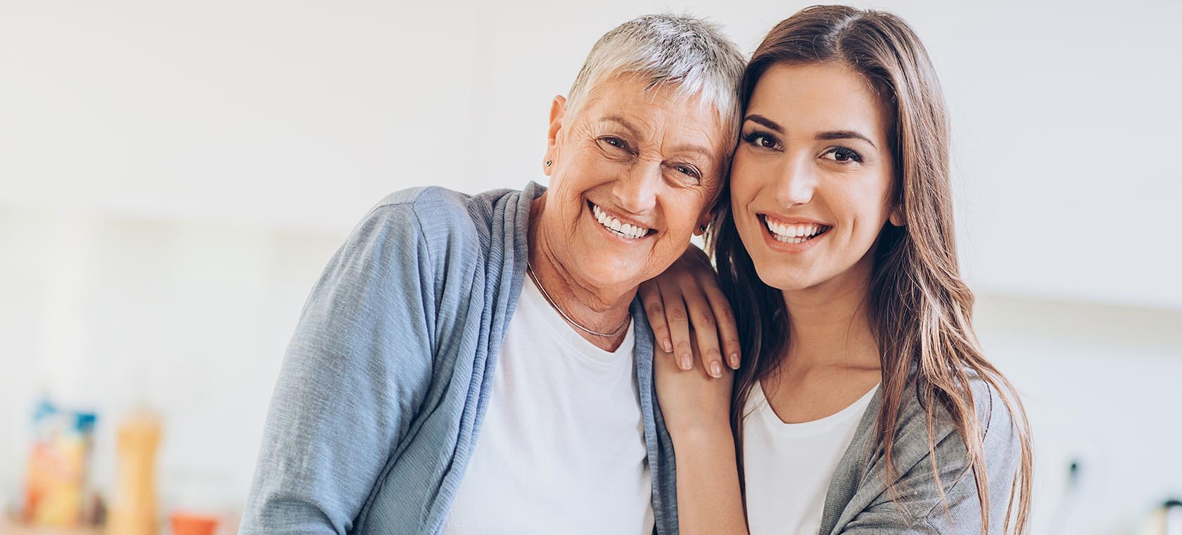 senior woman with dementia and her adult daughter smiling