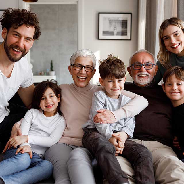 seniors with family on the couch after discussing senior living options